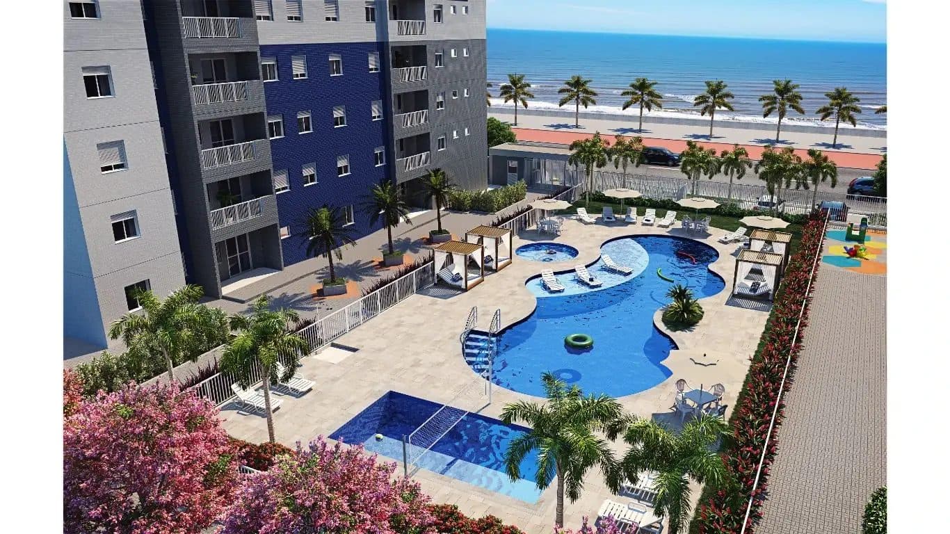 Area de piscina com espreguiçadeiras e vista para o mar