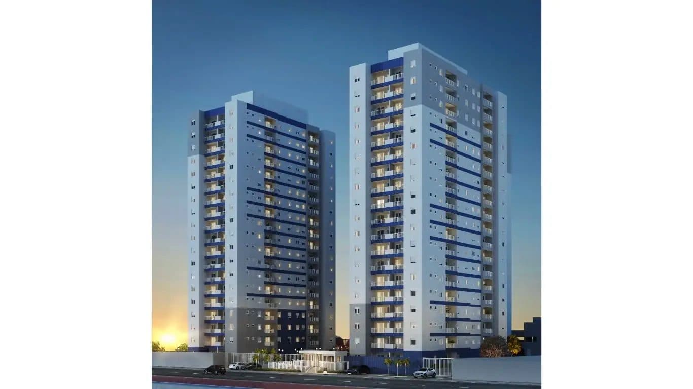 Fachada noturna de dois edifícios residenciais altos com pintura em tons de azul e cinza.