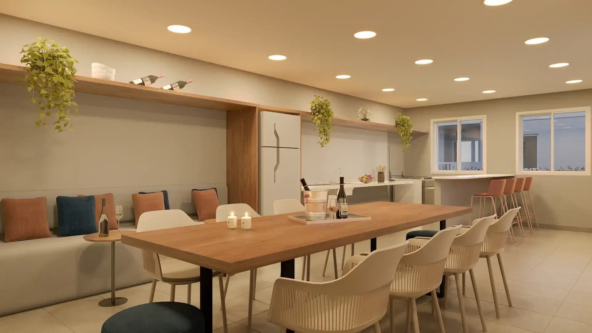 Espaço gourmet com mesa de jantar longa, bancada e acabamento amadeirado.